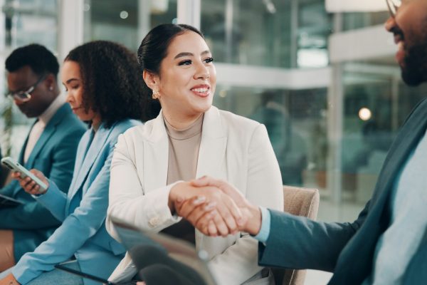 Woman, handshake and introduction at trade show, training or event discussion for gender equality.